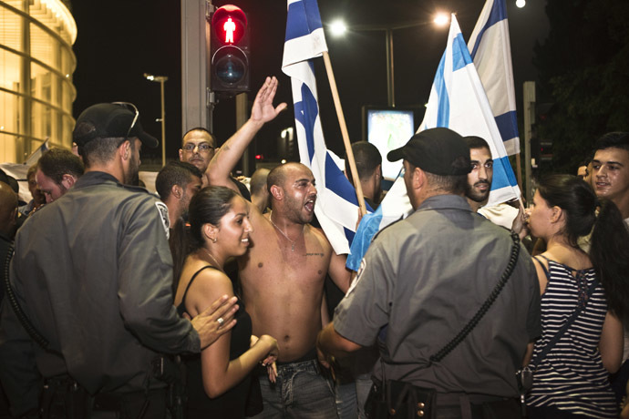 Right wing Israelis protest following an air raid siren warning of a rocket attack in Tel Aviv, July 12, 2014. (Reuters/Nir Elias)