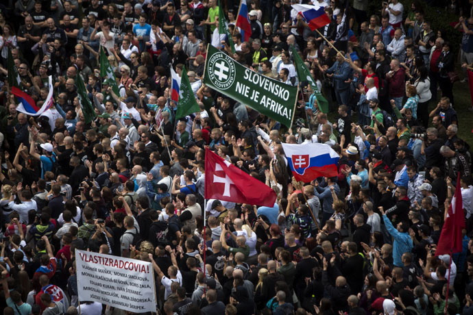 Participants wave flags and hold a banner reading "Slovakia is not Africa" during an anti-immigration rally organised by an initiative called "Stop Islamisation of Europe" and backed by the far-right "People's Party-Our Slovakia" on June 20, 2015 in Bratislava, Slovakia. (AFP Photo/Vladimir Simicek)